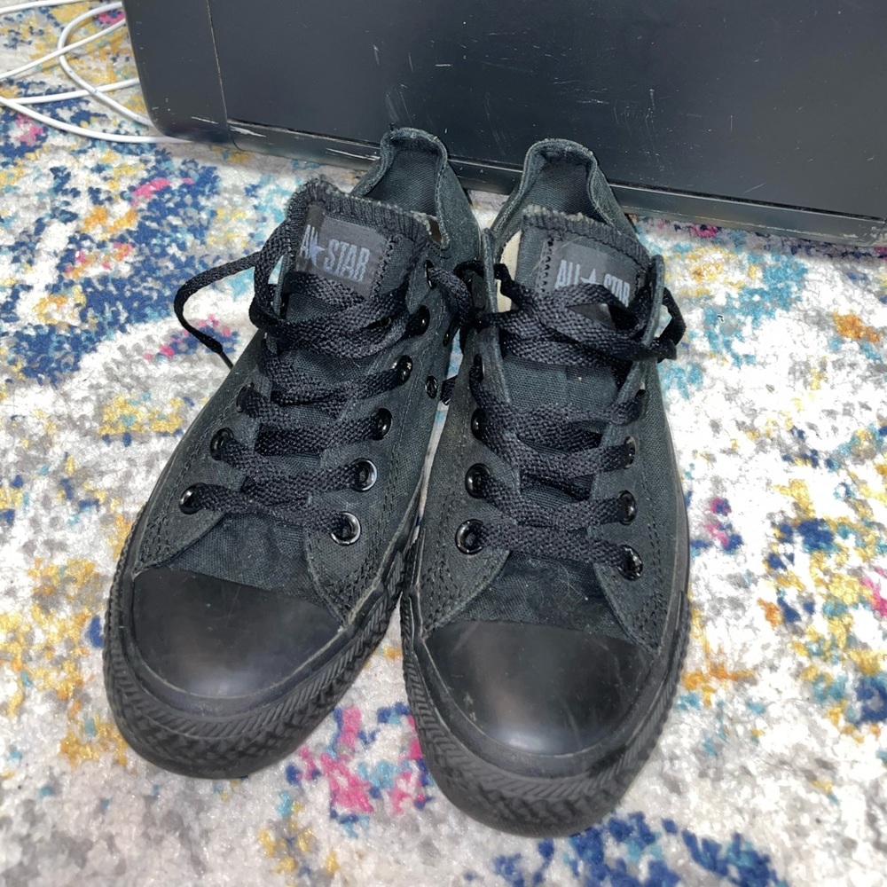 All black low top converse.